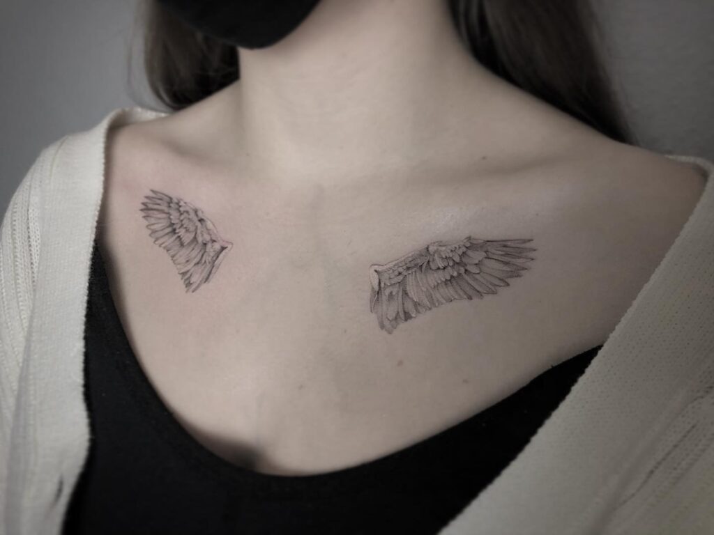 Minimal Angel Wings Tattoo with Dotwork Accent Tattoo Design