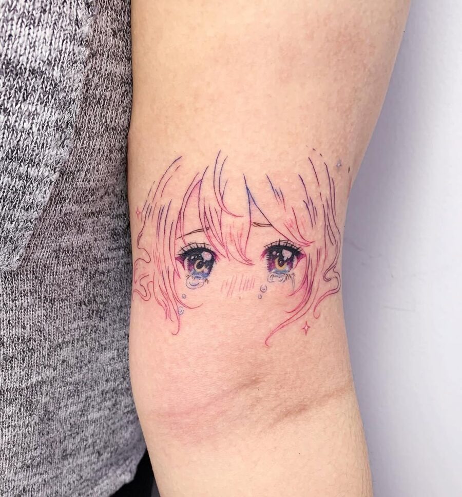 This tattoo features beautifully illustrated anime eyes with a soft pastel palette.