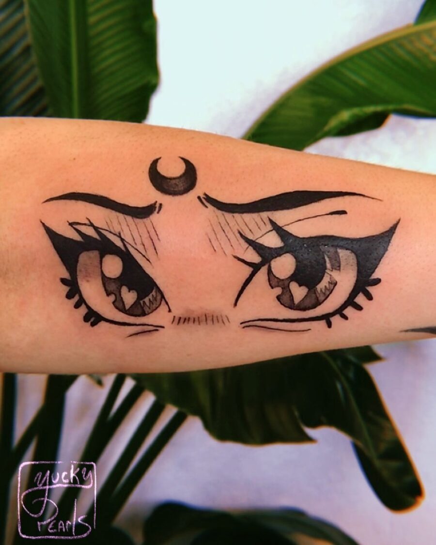 This tattoo features striking anime-style eyes, complete with heart shapes in the pupils.