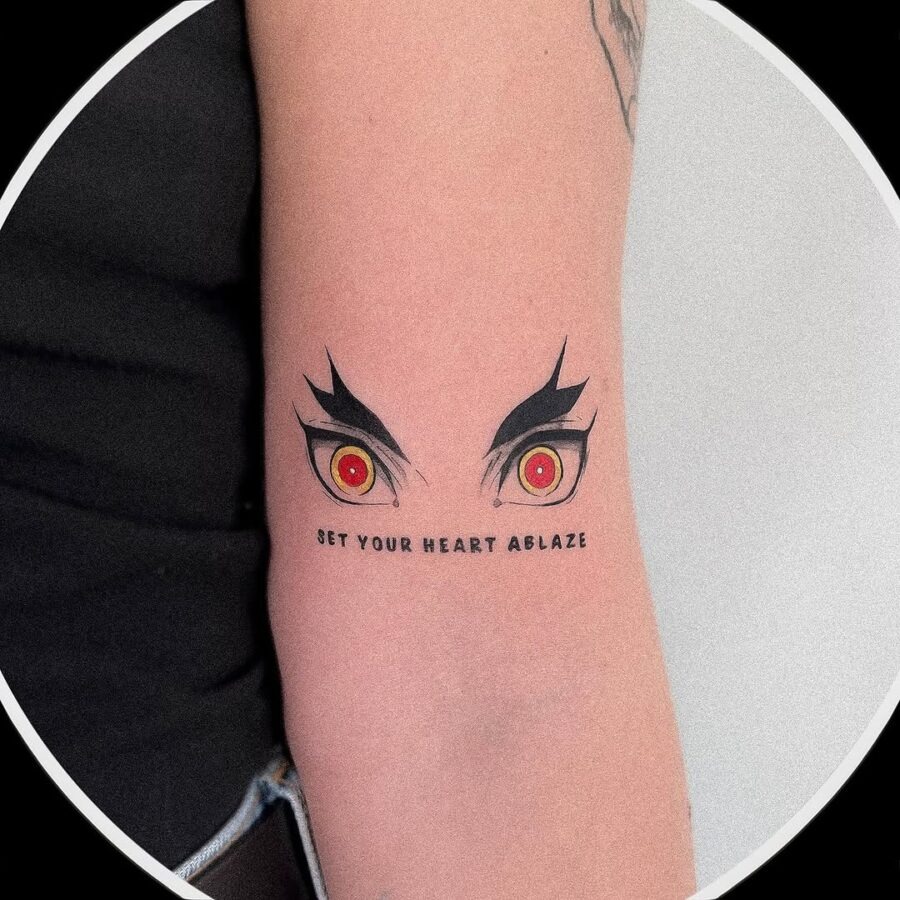 This tattoo showcases striking anime eyes, vividly designed with sharp lines and intense red irises.