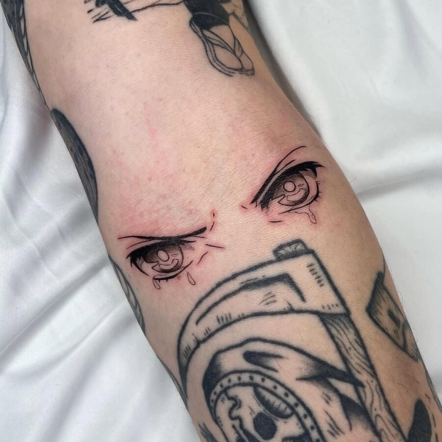 This tattoo features striking anime eyes that capture deep emotion.
