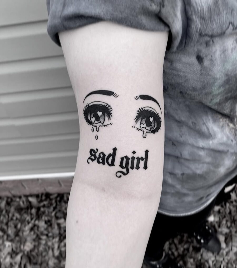 This tattoo features a striking pair of anime eyes adorned with teardrops, radiating an emotional vibe.