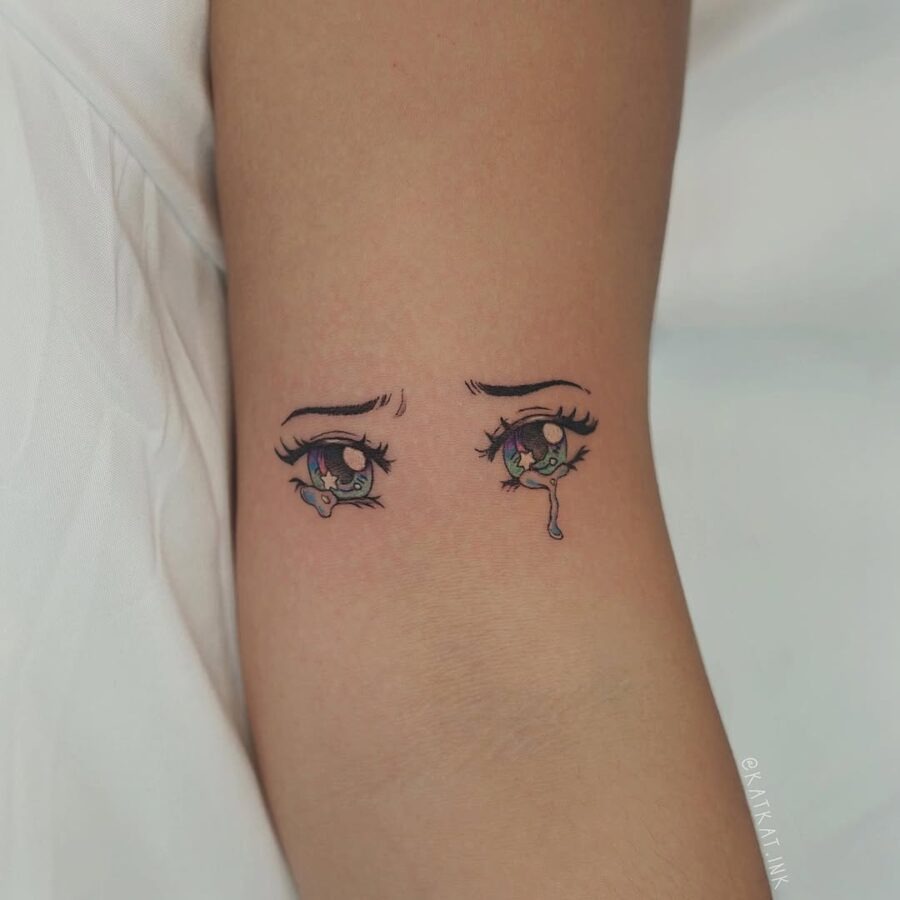 This tattoo features beautifully detailed anime eyes, capturing a range of emotions.