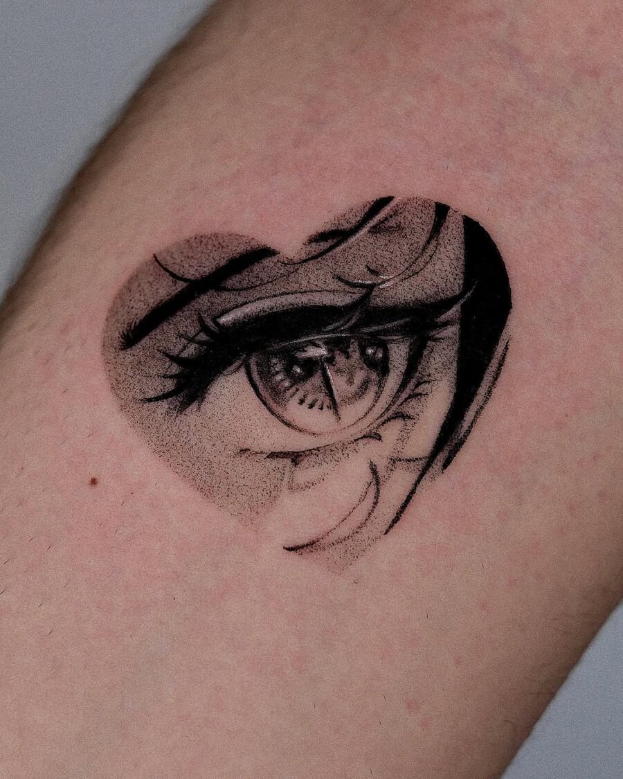 This unique tattoo combines a heart shape with an anime eye, creating a striking visual effect.