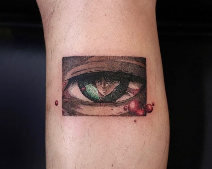 This tattoo showcases a stunning, realistic design of an anime eye with a character peering through.