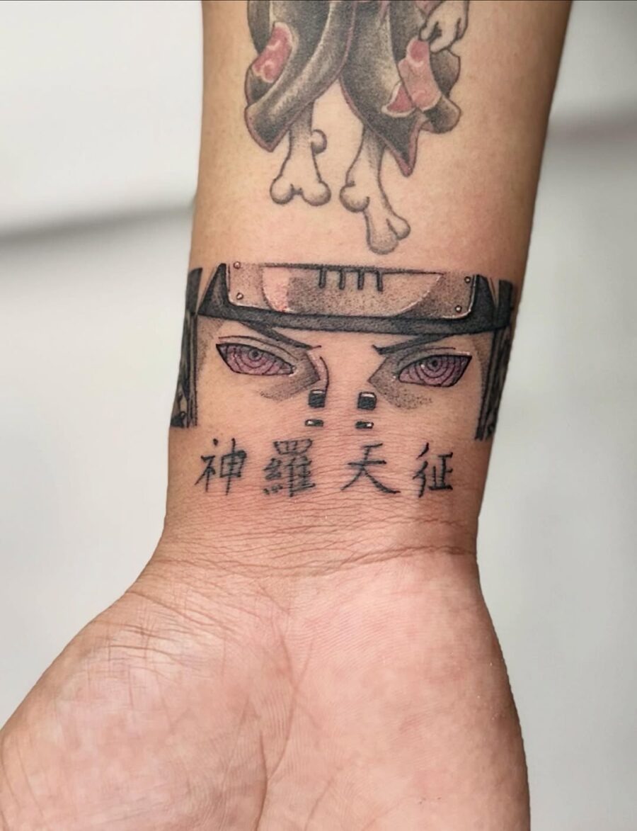 This tattoo features stylized anime eyes peering from a solid band, adding an intense vibe.