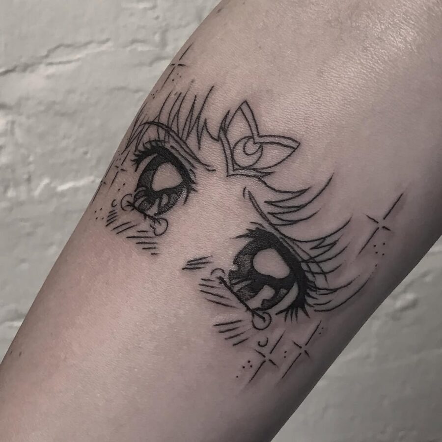 This tattoo features adorable anime eyes framed by delicate lashes, exuding a whimsical charm.