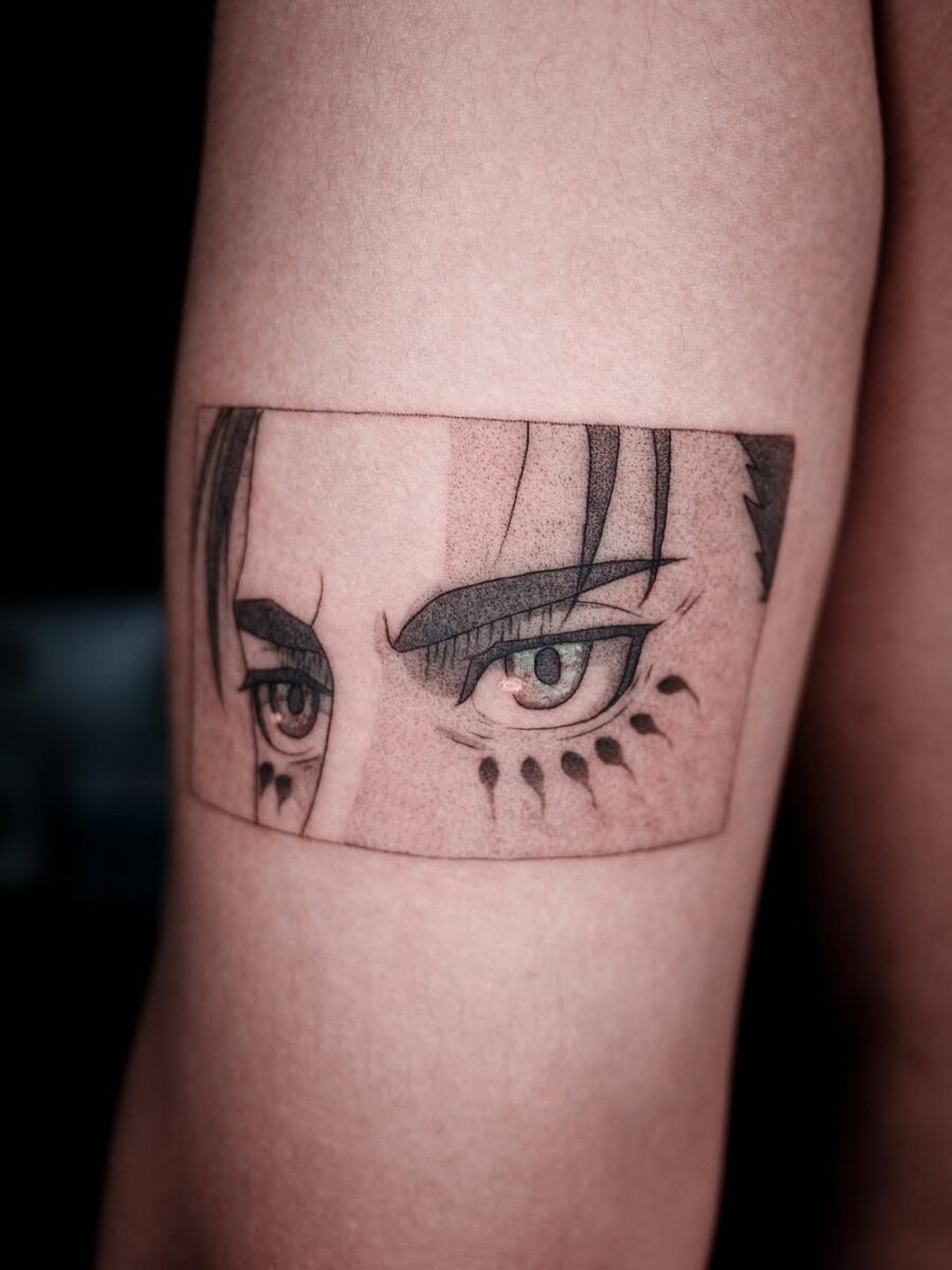 This tattoo features stunningly detailed anime eyes, showing an intense gaze and artistic depth.