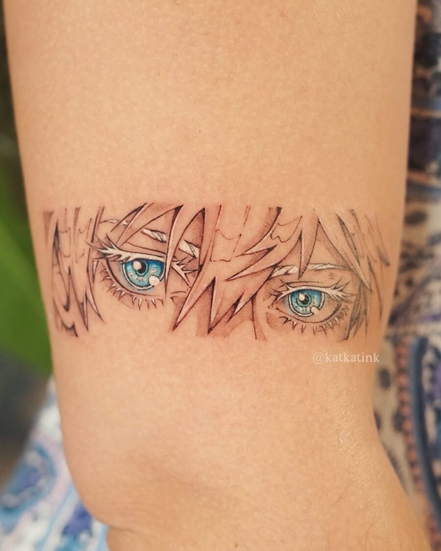 This tattoo features stunning blue anime eyes, skillfully detailed to capture emotion and depth.