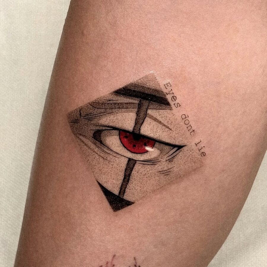 This tattoo features a captivating red eye, masterfully blending realism with an artistic flair.