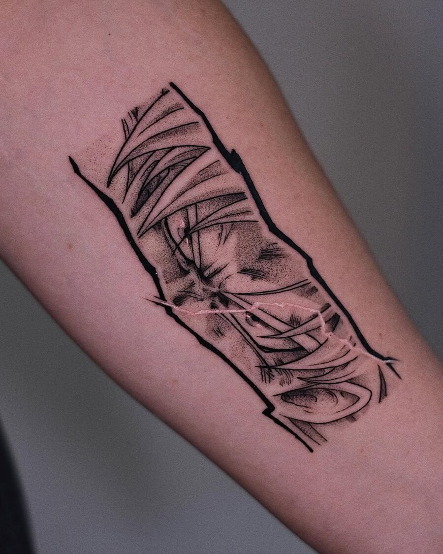 This tattoo features stylized anime eyes with an abstract twist, blending bold lines and shading.