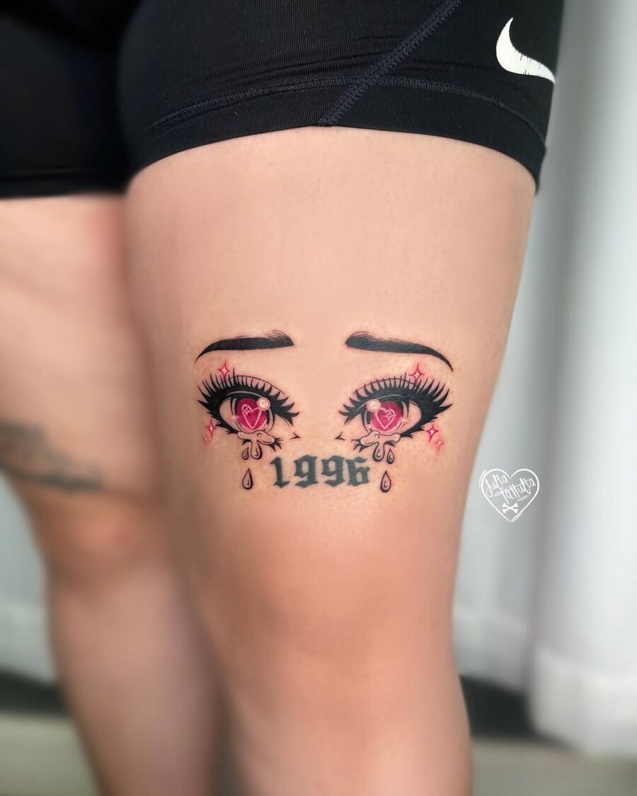 This tattoo showcases striking anime-style eyes adorned with elegant lashes and hearts.