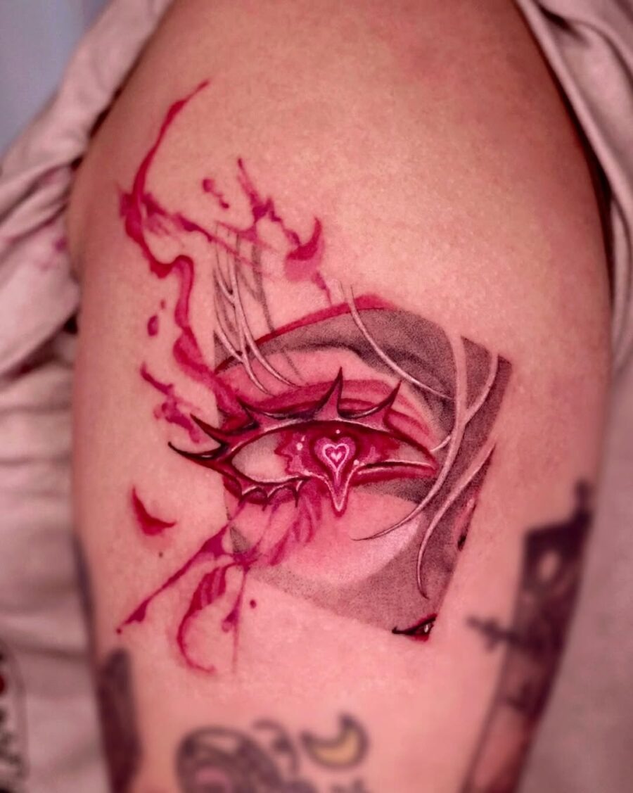 This tattoo features a mesmerizing anime eye surrounded by red splashes, creating a captivating visual effect.