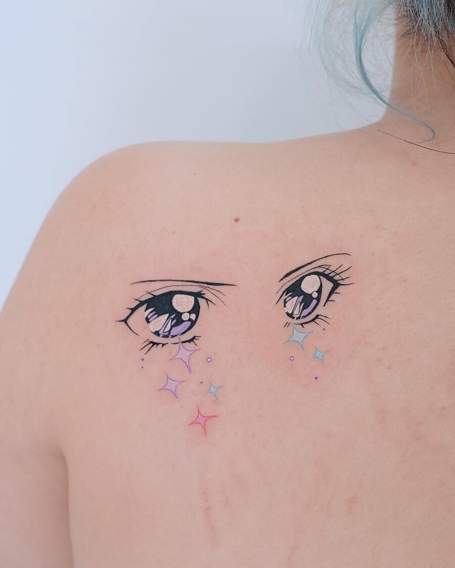 This tattoo features stunning anime-style eyes adorned with colorful sparkles that add a whimsical touch.
