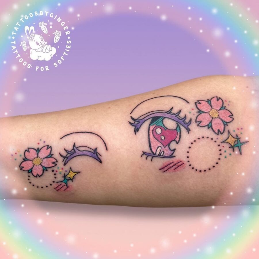 This playful tattoo features a pair of anime-style eyes, complemented by bright flowers and whimsical elements.