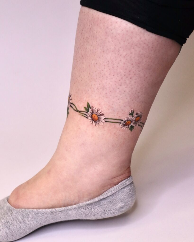 Simple Daisy Tattoo on Upper Arm Tattoo Design