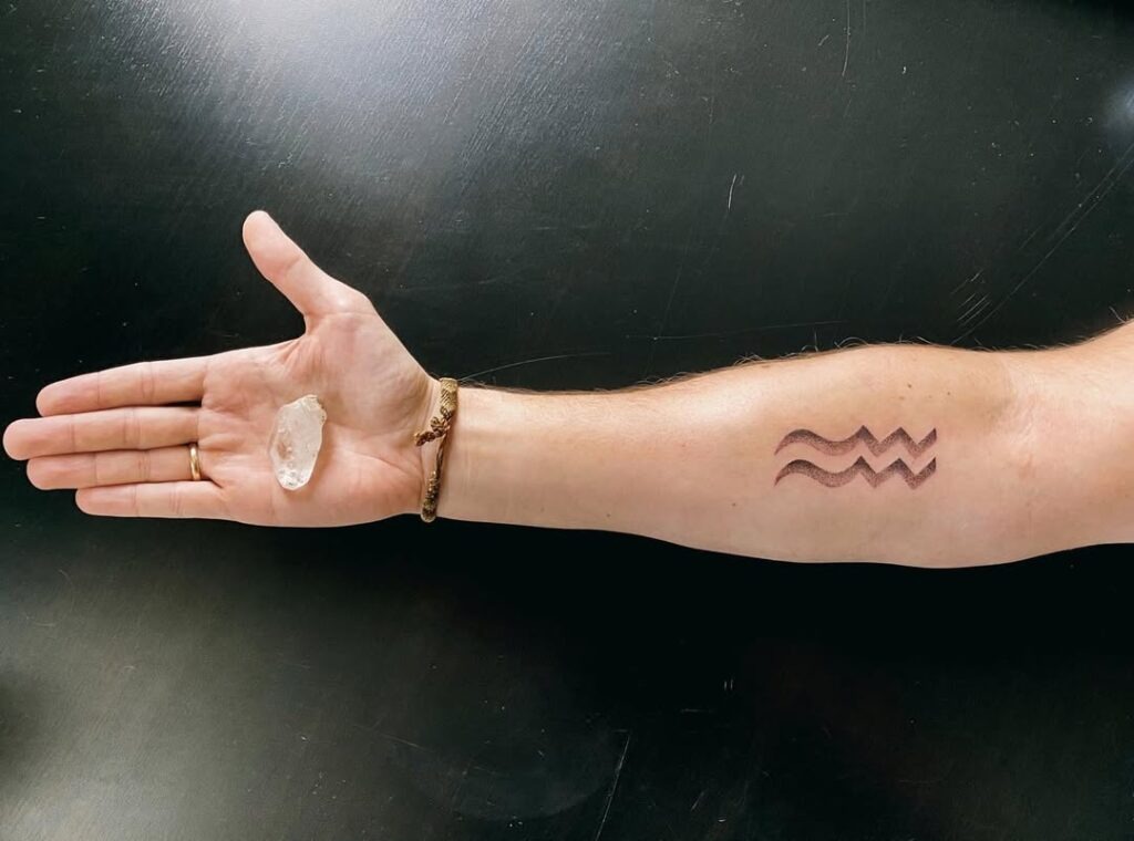 Bold Aquarius Wave Symbol Tattoo on the Forearm Tattoo Design