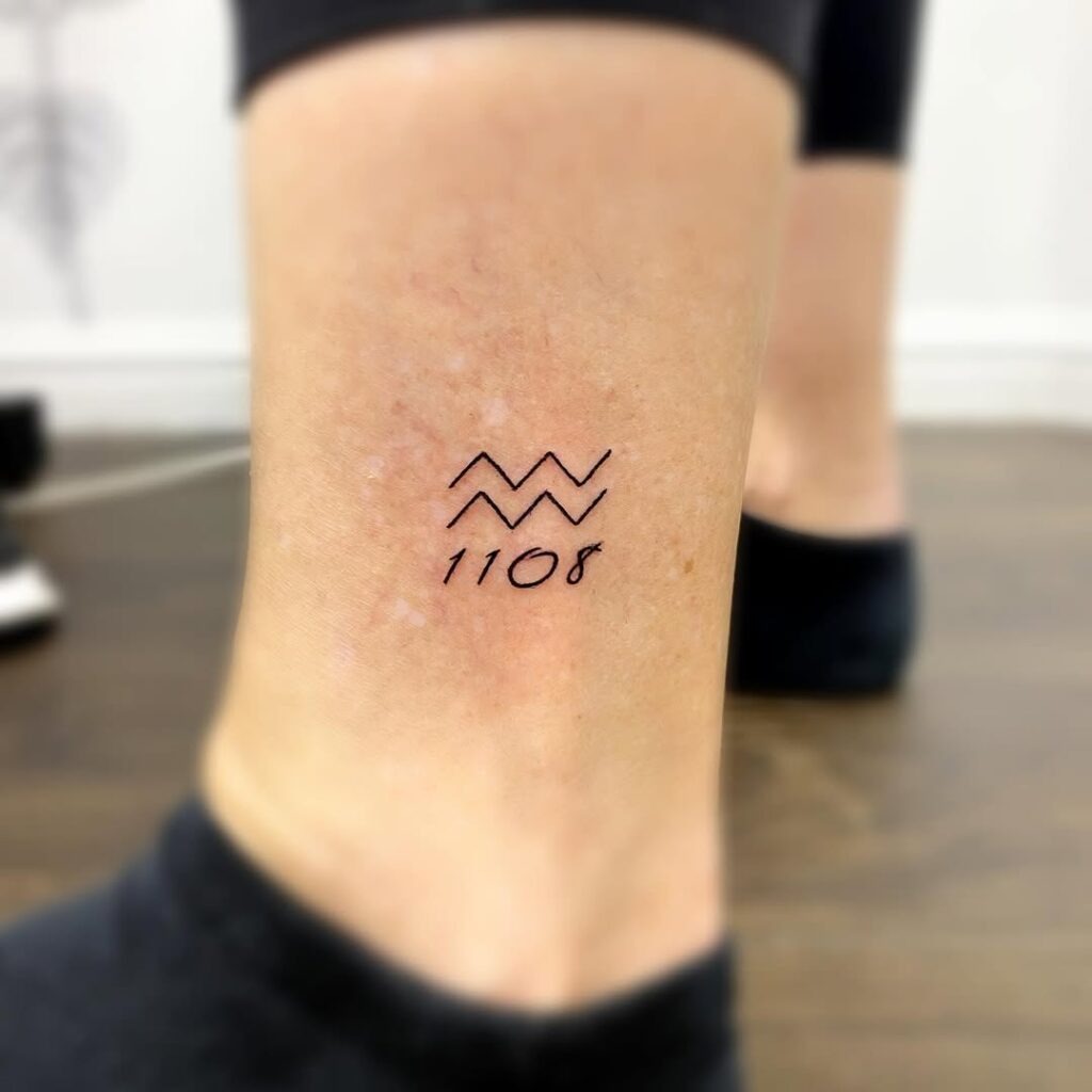 Minimalist Aquarius Wave Symbol Tattoo with Date on the Ankle Tattoo Design
