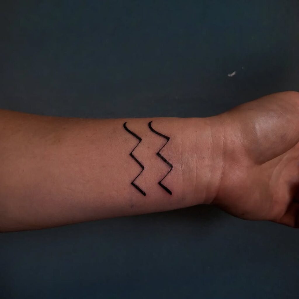 Simple Aquarius Wave Symbol Tattoo on the Wrist Tattoo Design