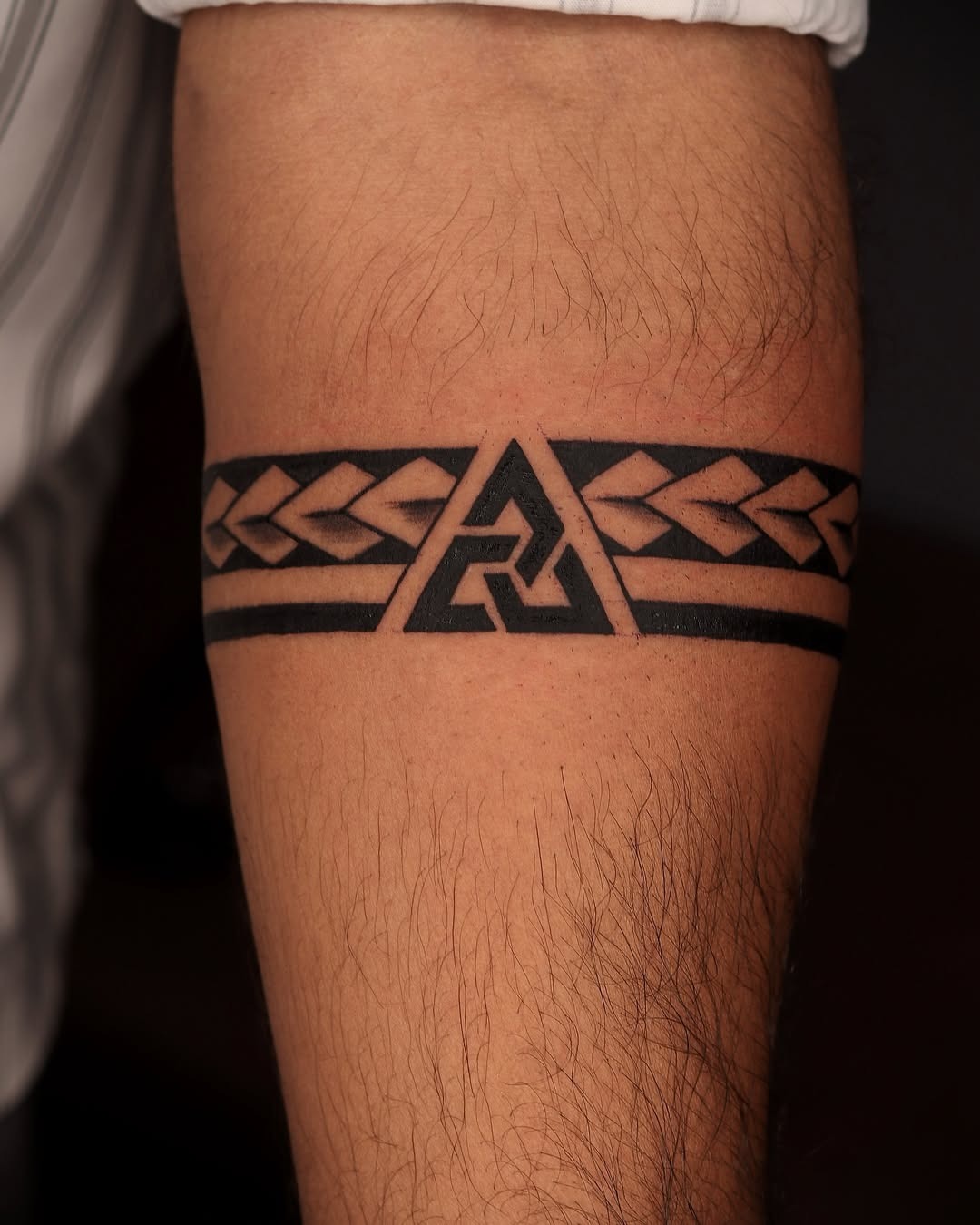 Bold geometric armband tattoo with tribal elements Tattoo Design