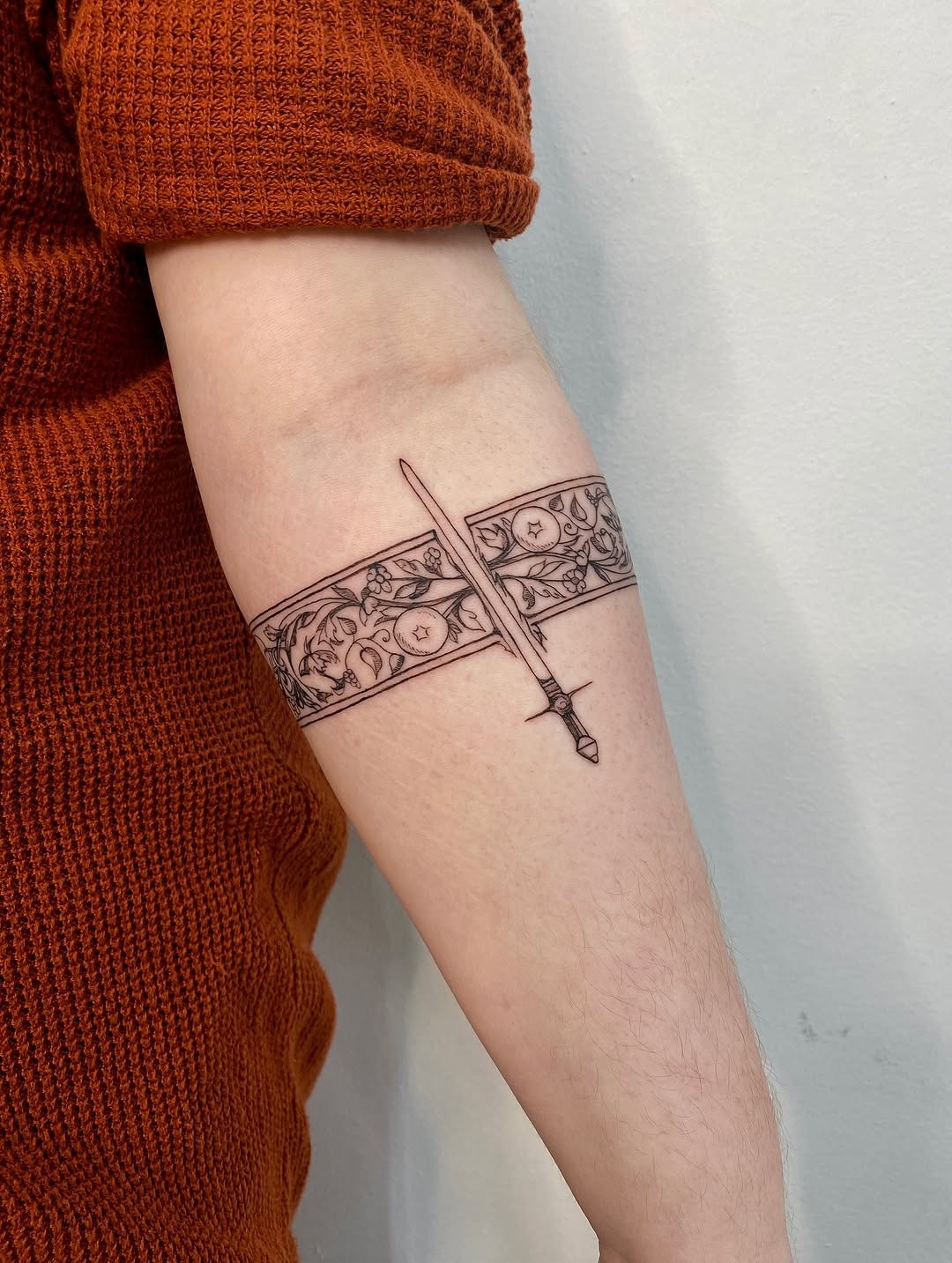Elegant sword design with floral accents Tattoo Design