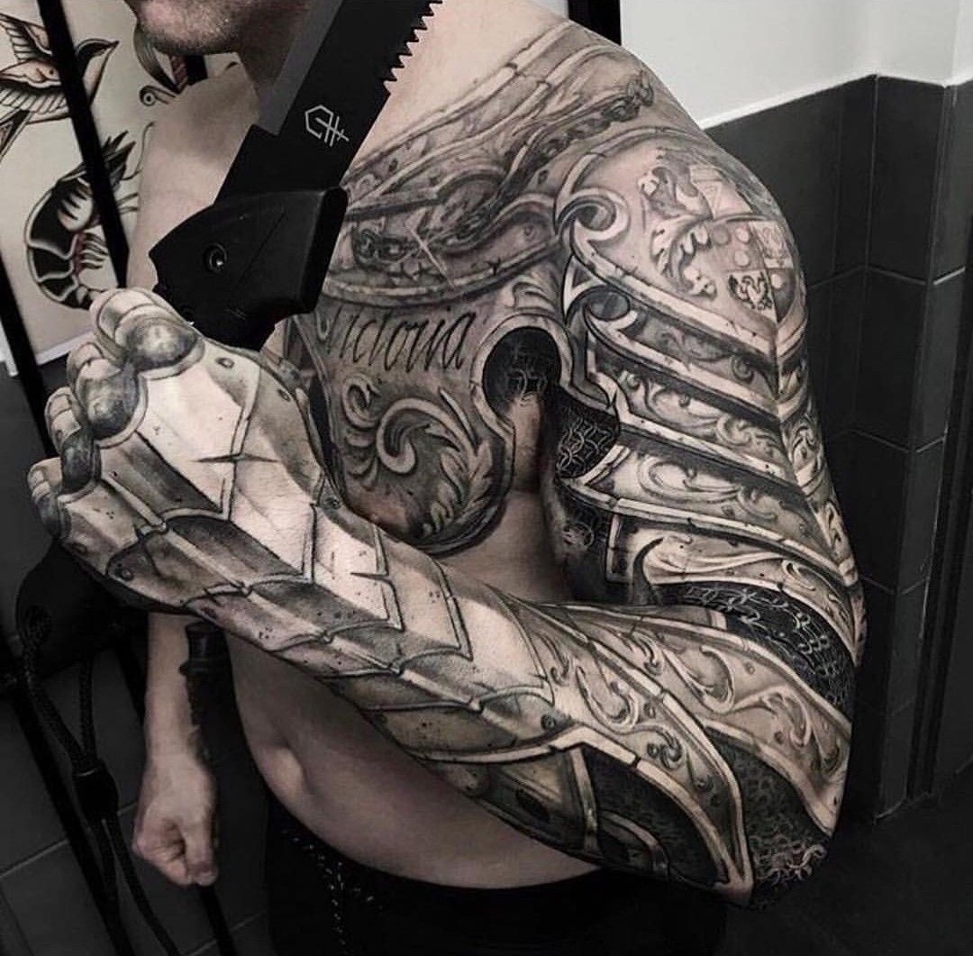 Ornate Shoulder Armor with Gothic Crest Tattoo Design