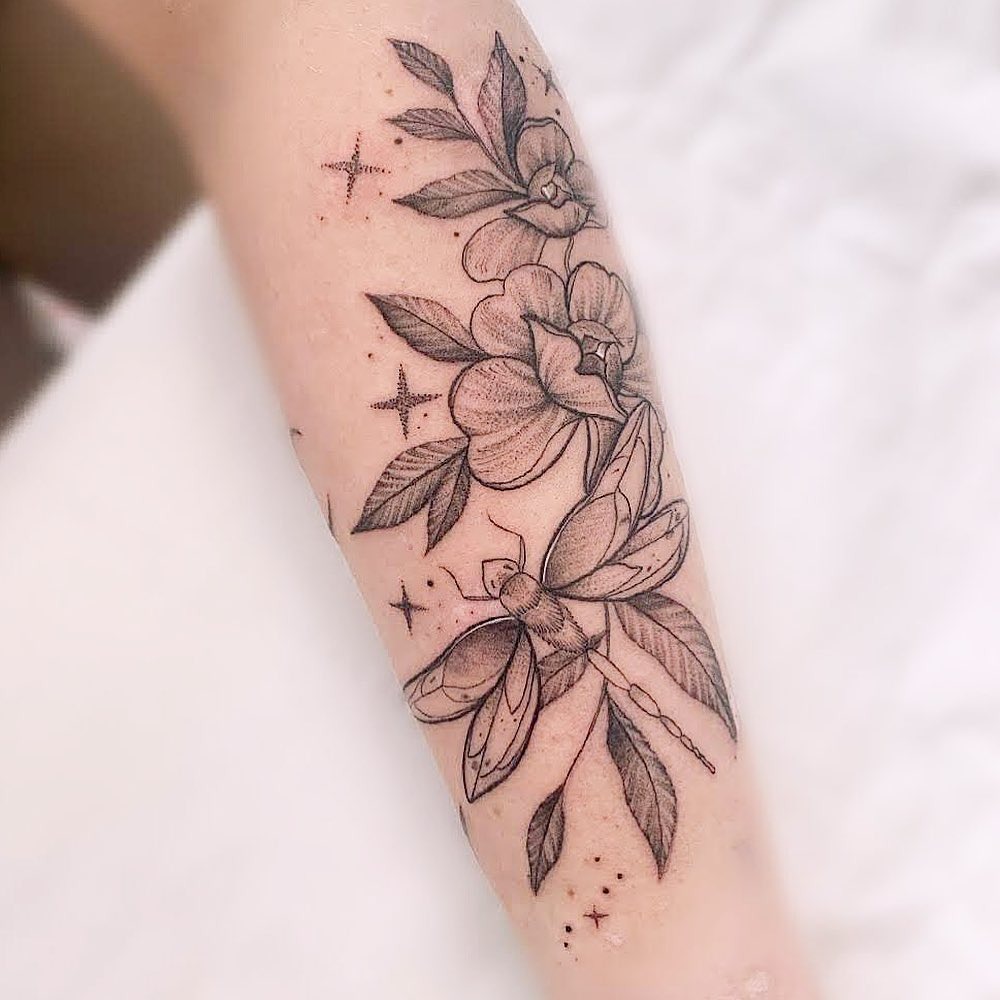 Delicate dragonfly tattoo with floral accents Tattoo Design
