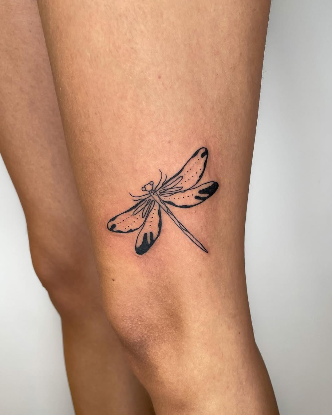 Detailed black ink dragonfly tattoo on leg Tattoo Design