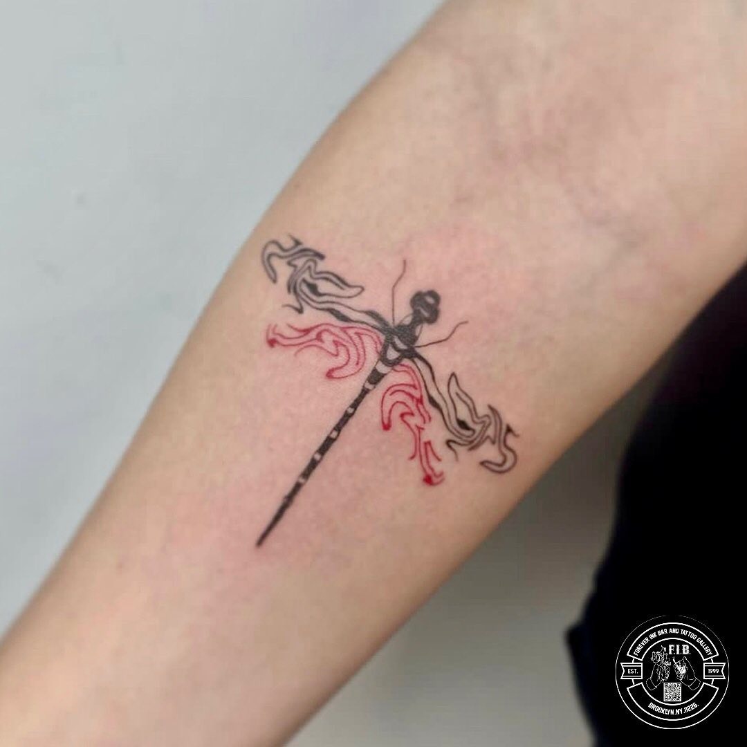 Elegant dragonfly tattoo blending color and design Tattoo Design