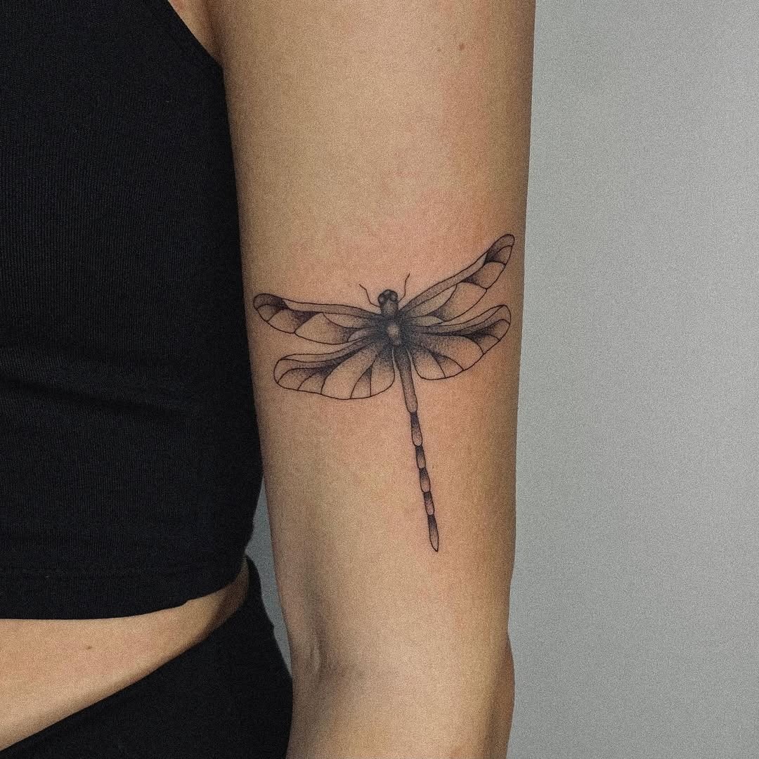 Elegant dragonfly tattoo on a forearm Tattoo Design