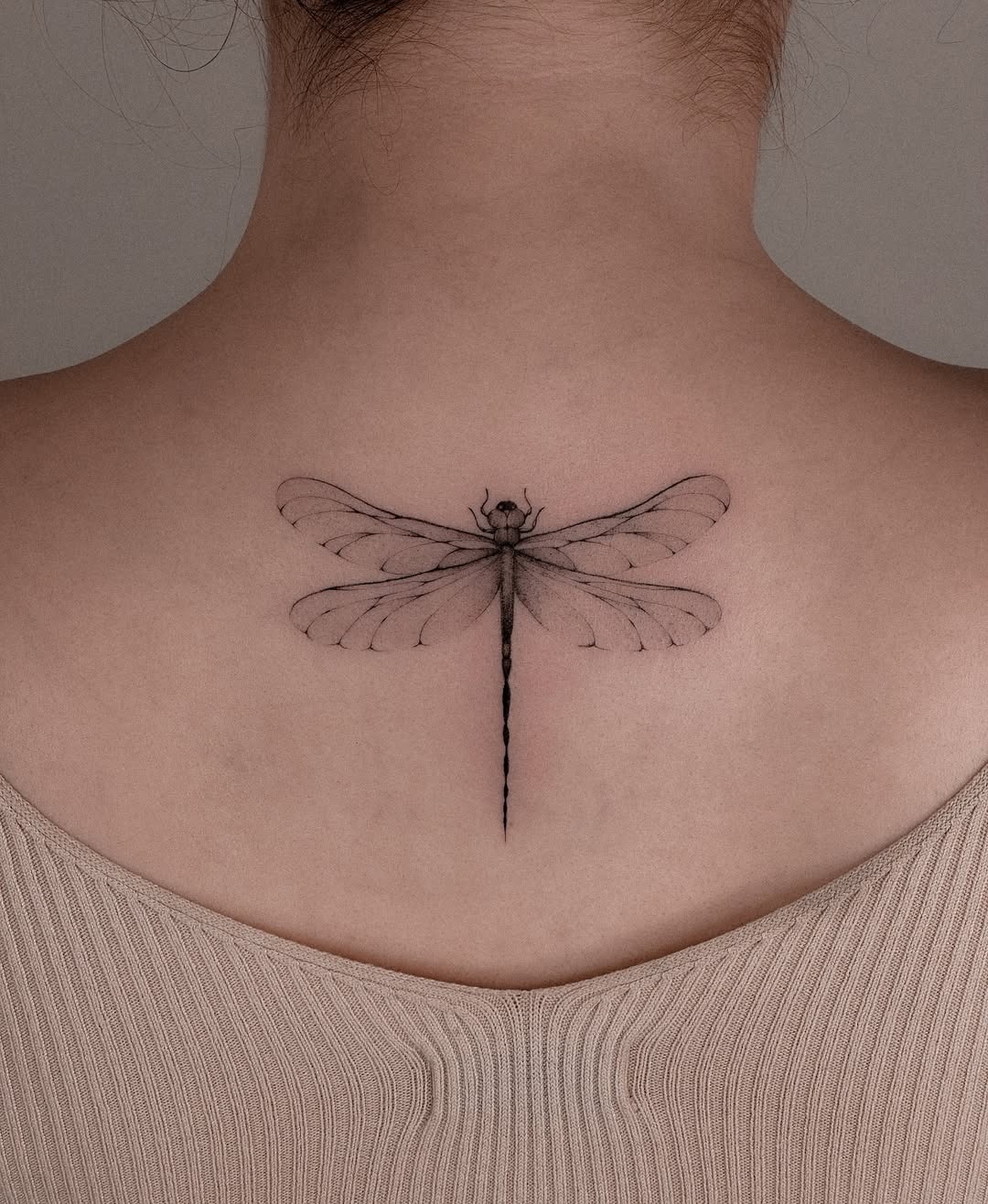 Elegant Dragonfly Tattoo on a Woman’s Back Tattoo Design