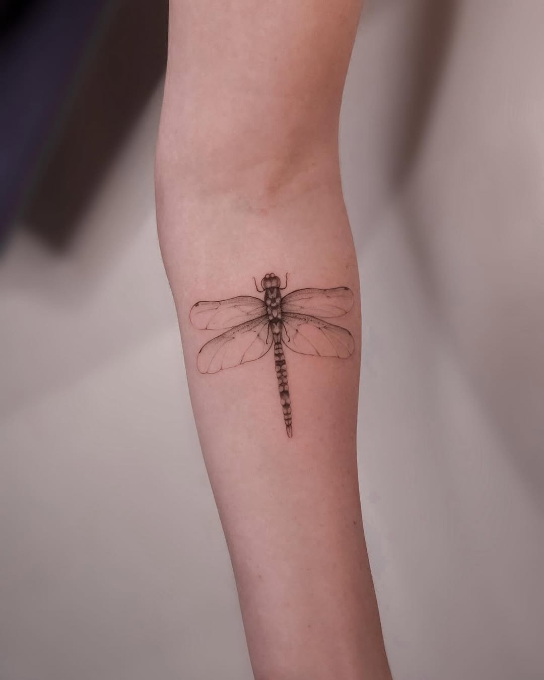 Elegant Dragonfly Tattoo on Bare Skin Tattoo Design