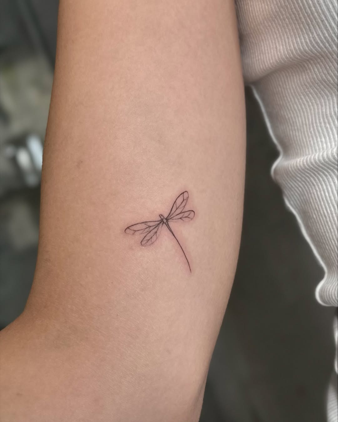 Elegant Fine Line Dragonfly Tattoo on Skin Tattoo Design