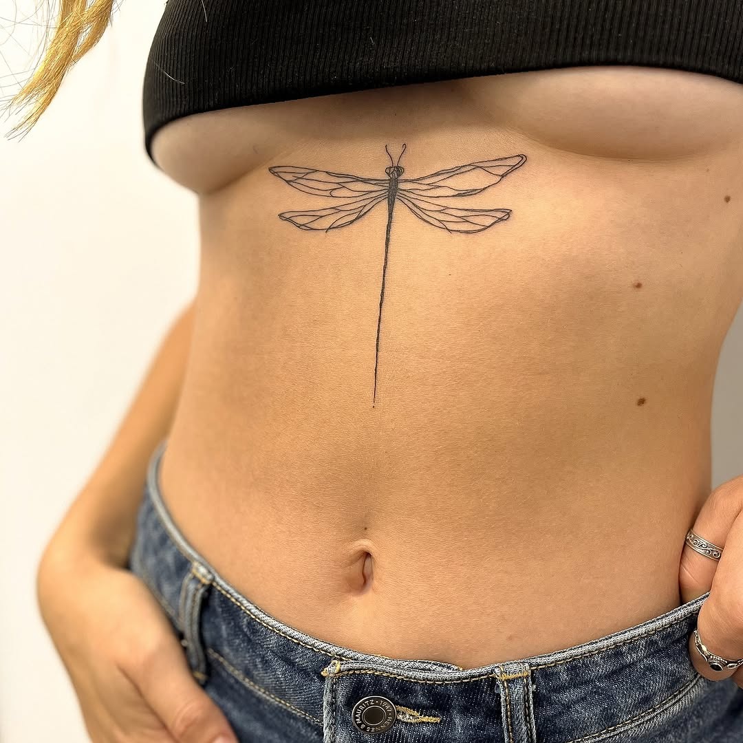 Elegant Minimalist Dragonfly Tattoo on Skin Tattoo Design