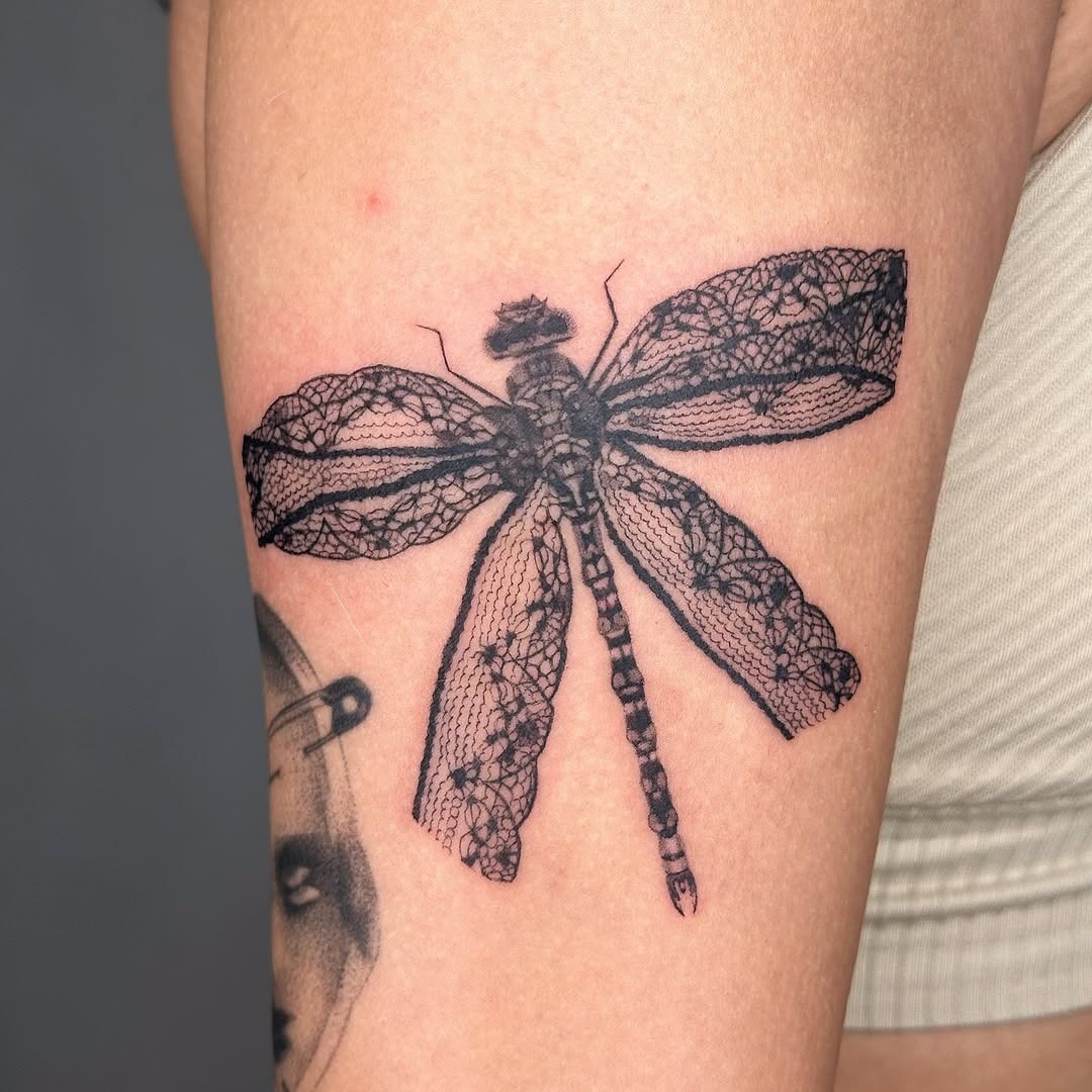 Intricate dragonfly tattoo with lace detailing Tattoo Design