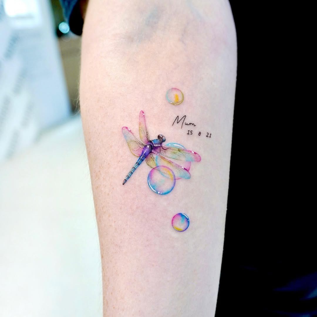 Vibrant dragonfly tattoo surrounded by playful bubbles Tattoo Design
