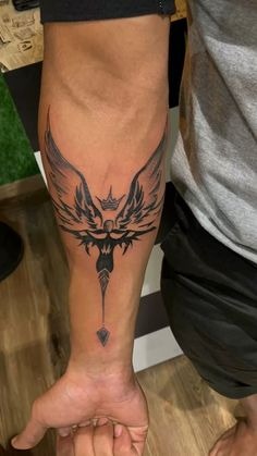 This tribal-inspired forearm tattoo is characterized by sharp lines and bold shapes that create a striking visual effect.