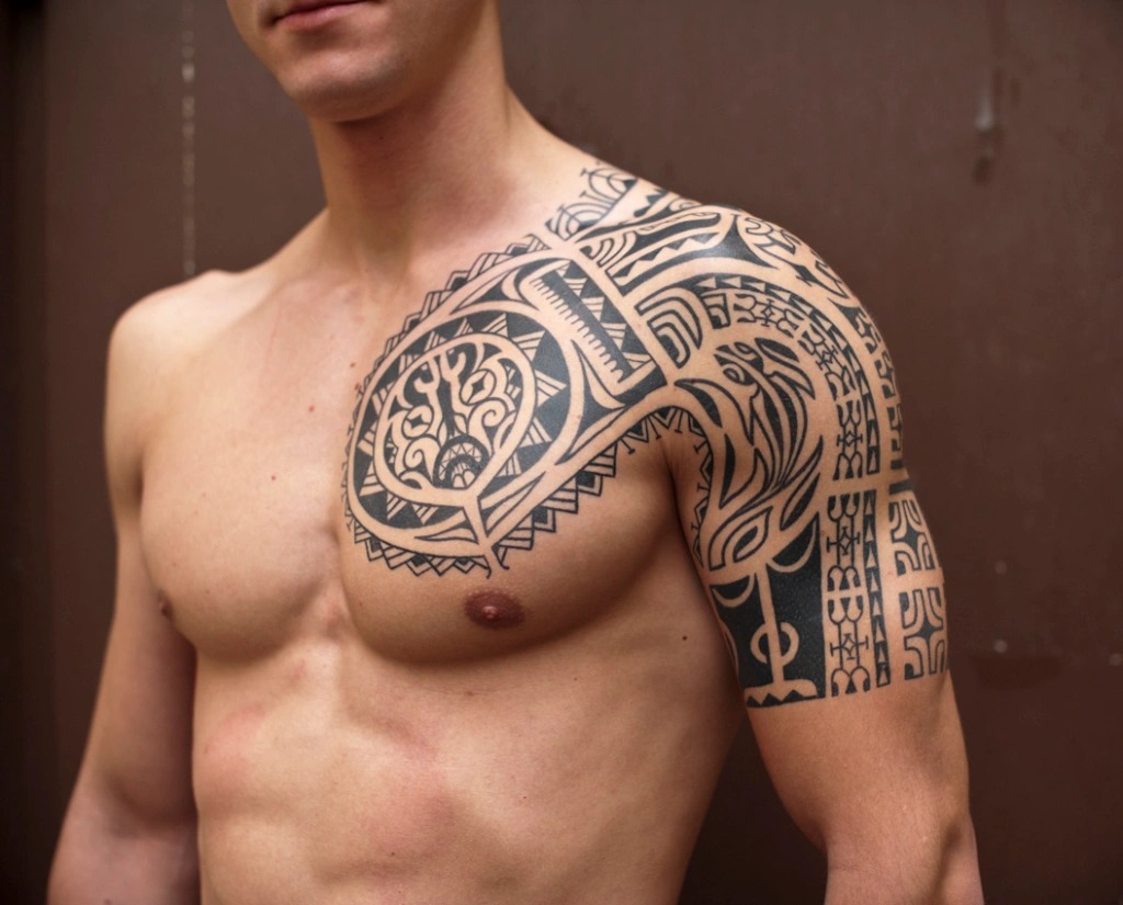 This Polynesian-inspired shoulder and chest tattoo merges tradition with bold design.