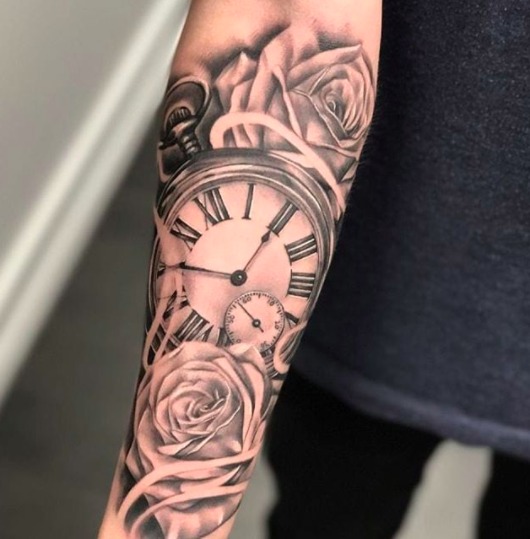 A popular and timeless choice, this tattoo design features a beautifully detailed Roman numeral clock surrounded by elegant roses.