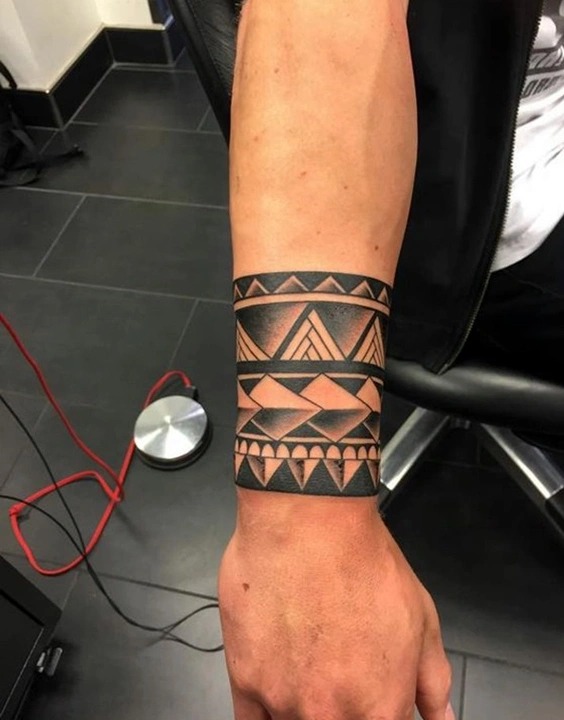 Bold and striking, this tribal-inspired forearm band is perfect for those who appreciate the raw power of geometric patterns.