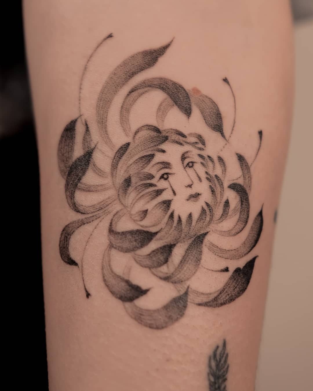 A mesmerizing flower with a hidden face Tattoo Design