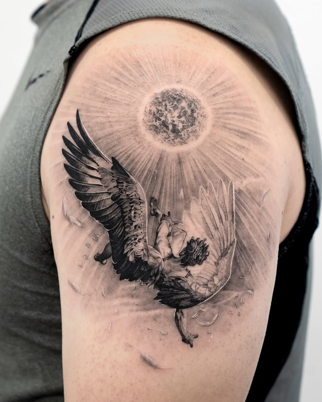 Dramatic winged figure under radiant sun. Tattoo Design