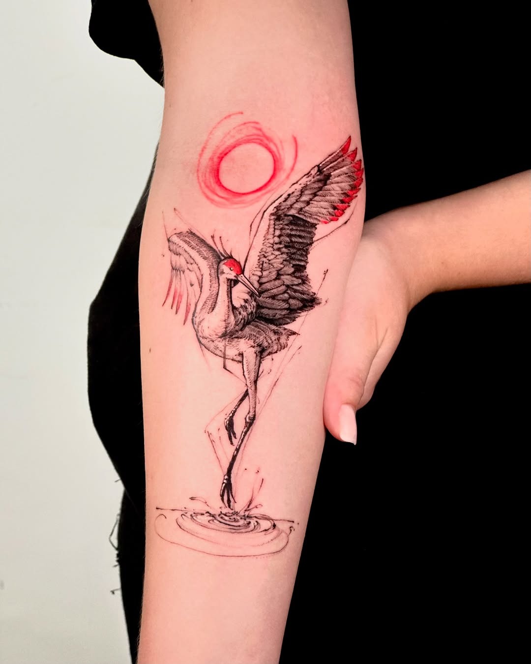 Elegant crane tattoo with red sun accent Tattoo Design