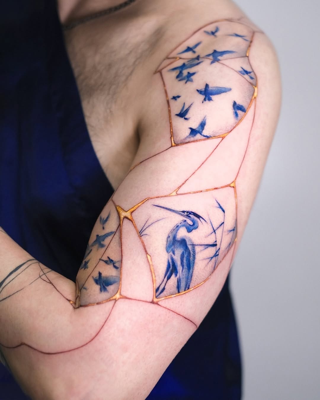 Unique bird and star tattoo composition on arm Tattoo Design