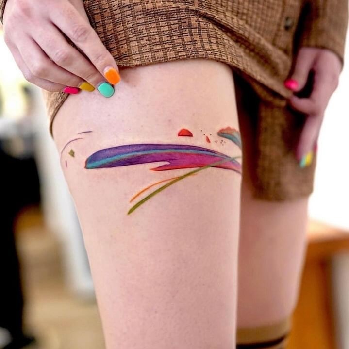 Vibrant abstract thigh tattoo in bold colors Tattoo Design