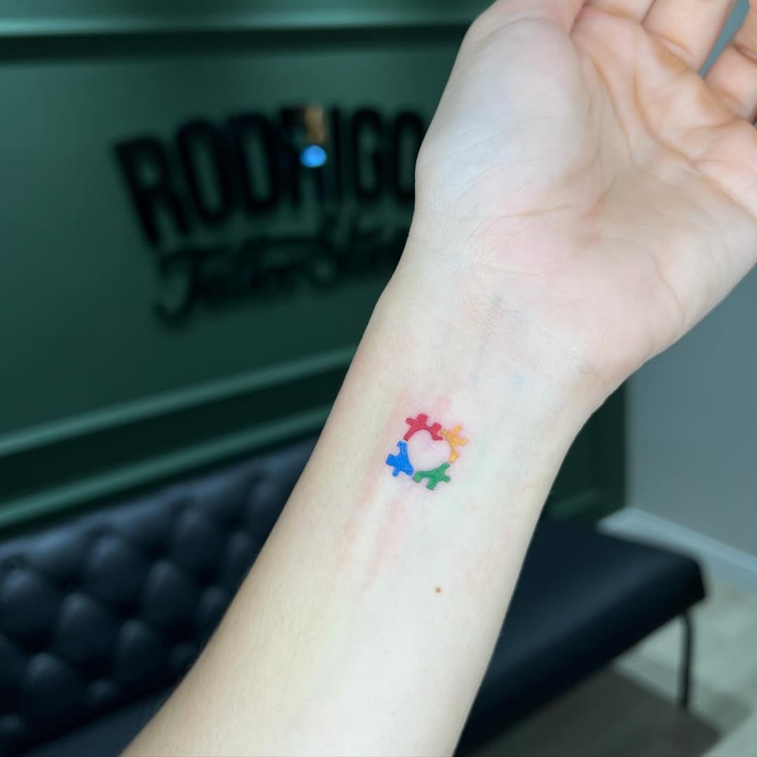 Colorful autism symbols on wrist tattoo Tattoo Design