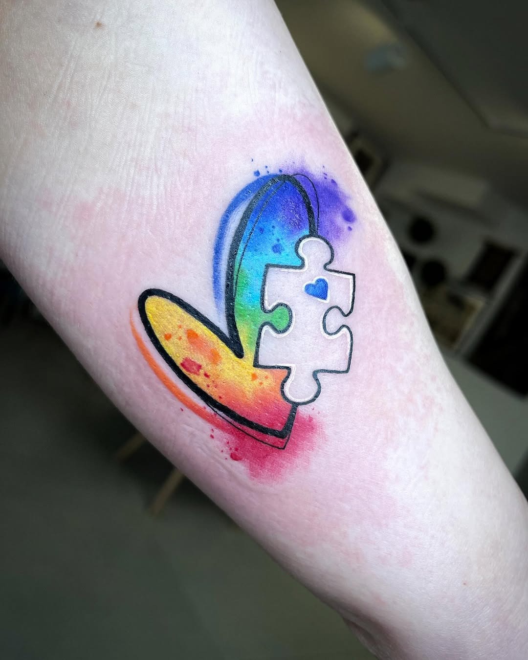 Colorful heart tattoo symbolizing autism awareness Tattoo Design