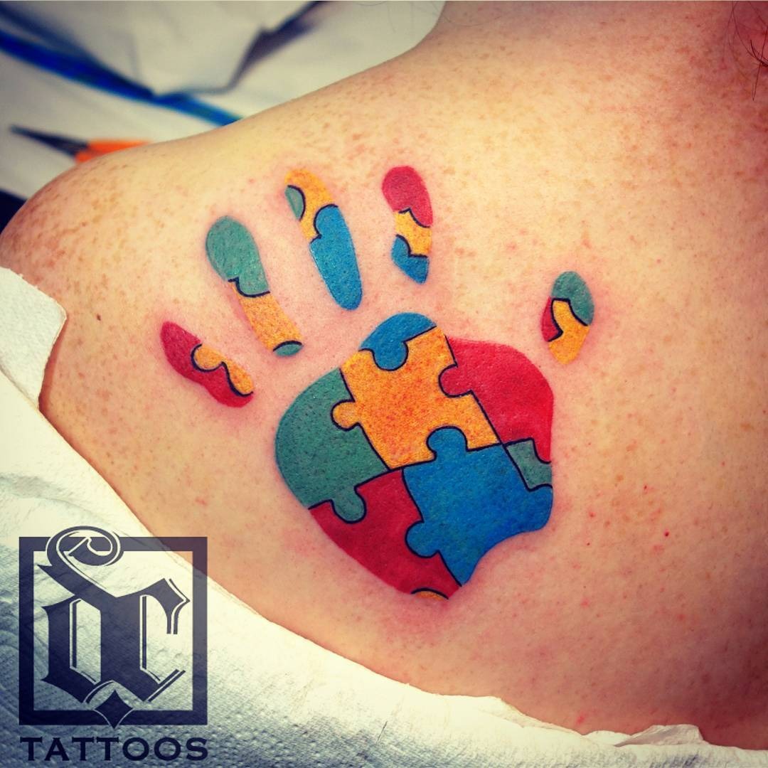 Colorful puzzle piece hand tattoo design Tattoo Design