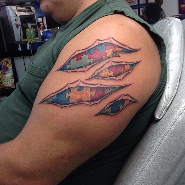 Colorful puzzle piece tattoo showcasing autism awareness Tattoo Design