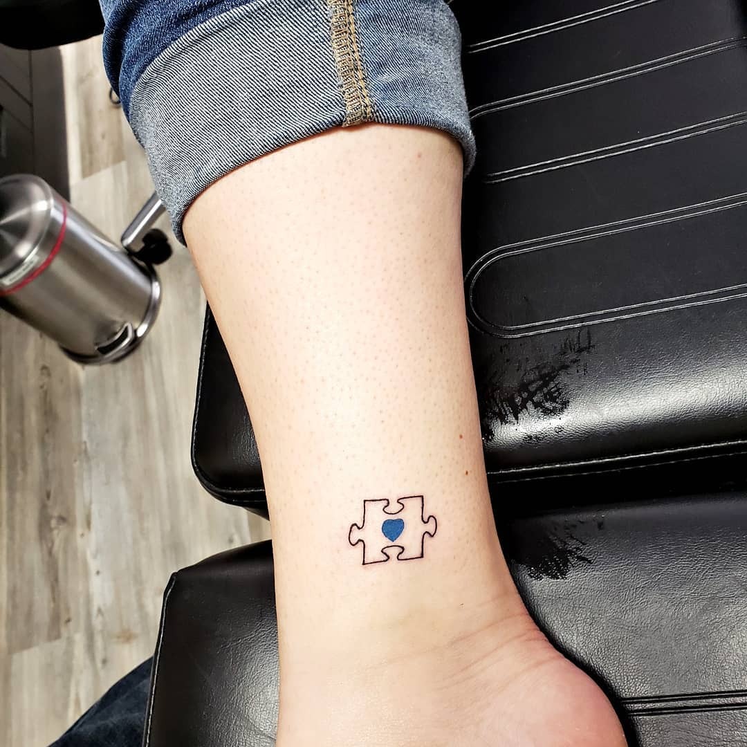 Stylish puzzle piece tattoo with heart Tattoo Design